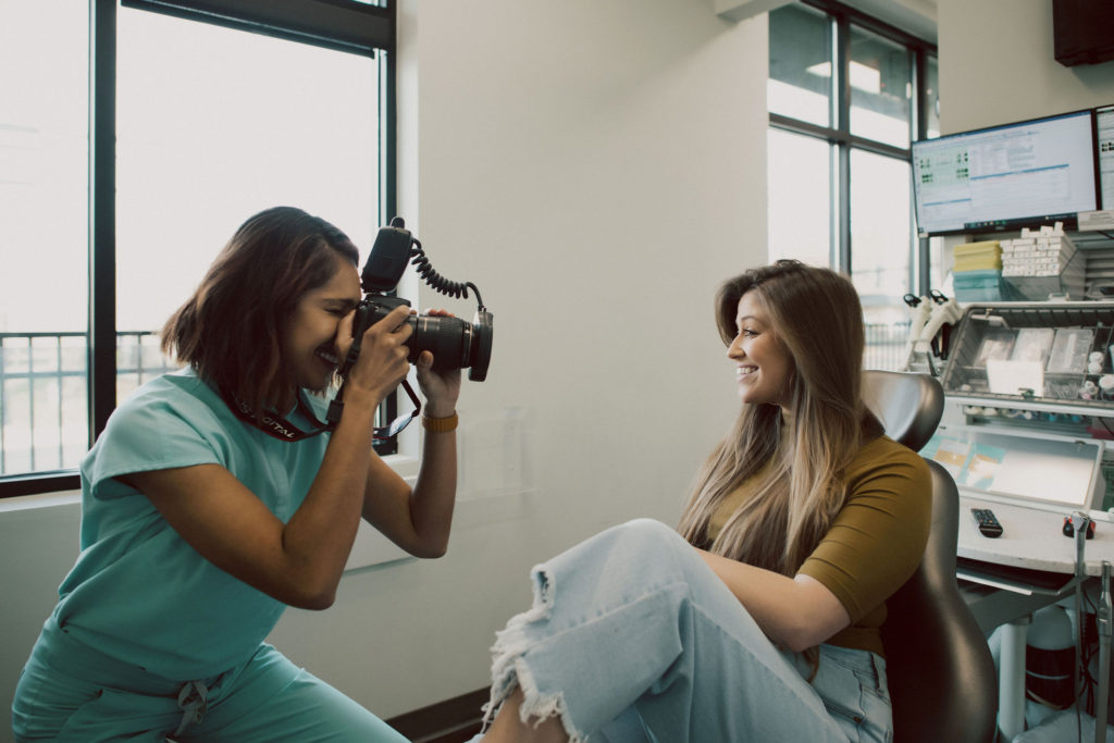 Dr. Kamodia, dentist in Mint Hill NC, photographing a patient's smile at Mint Hill Smiles