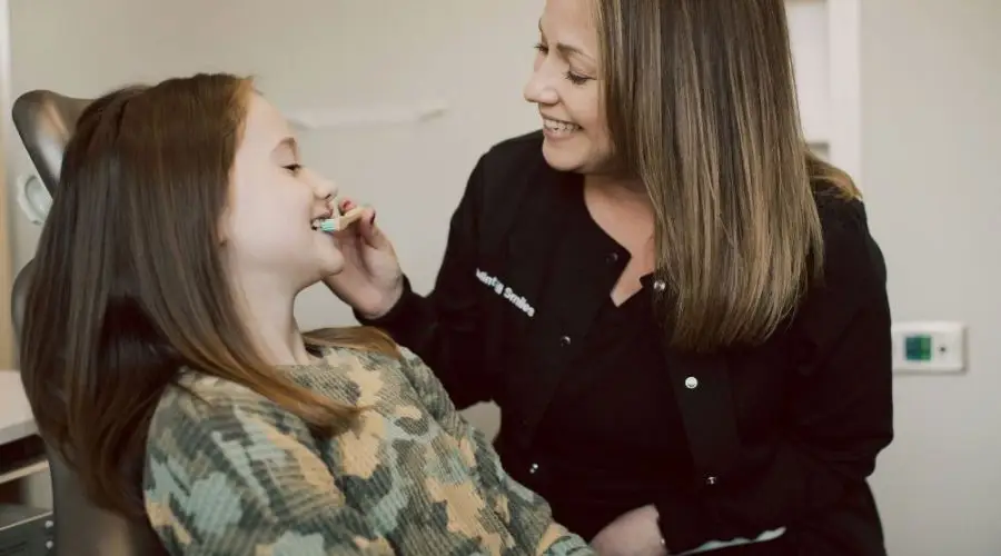Child receiving gentle dental care after a traumatic dental experience.