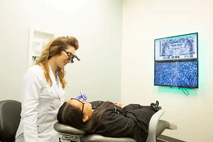 Mint Hill dentist performing regular dental check up to a patient to prevent gum disease.